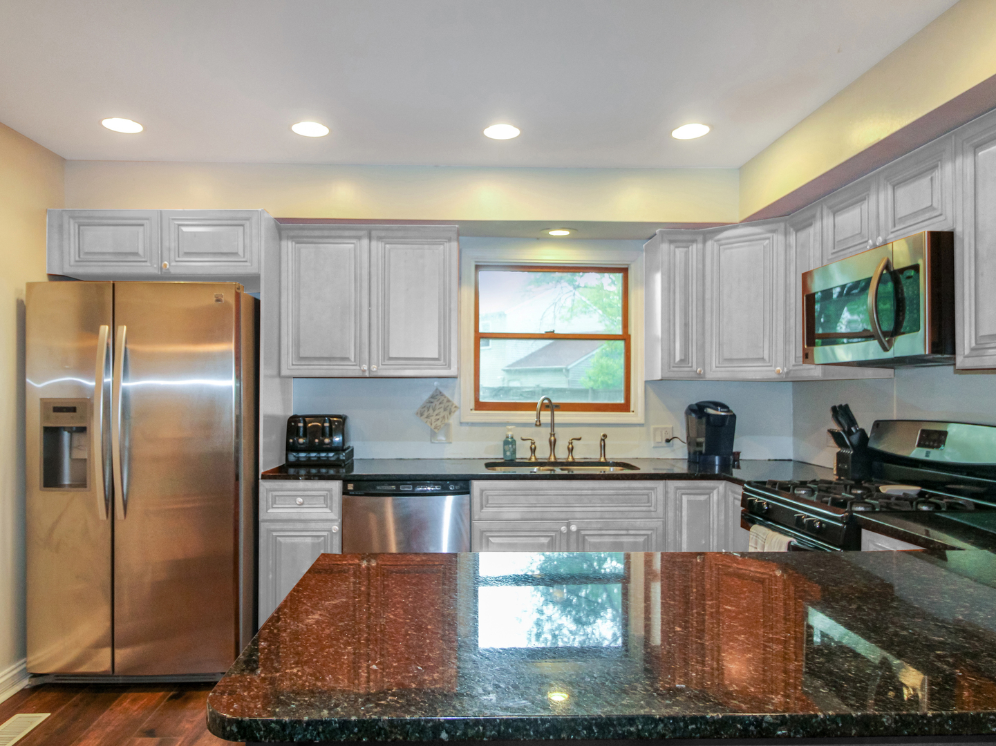 552 Spruce Road Bolingbrook, IL 60440 - Photo 4 of 18 a kitchen with stainless steel appliances granite countertop a stove a sink and a refrigerator