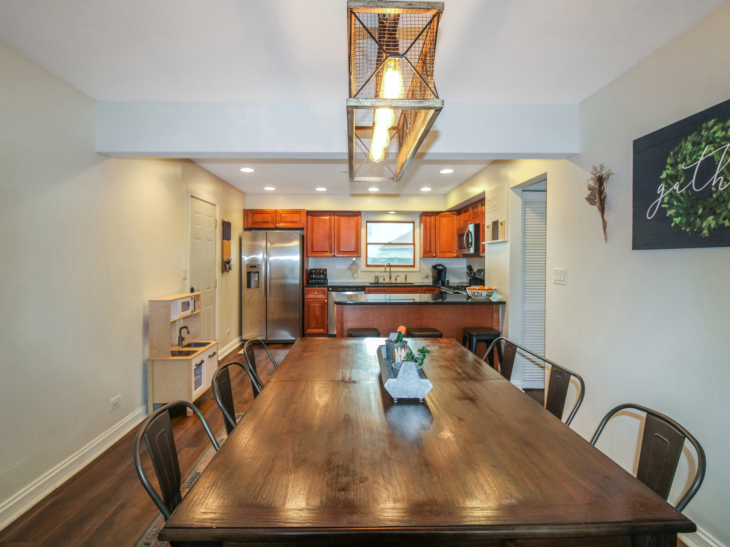 552 Spruce Road Bolingbrook, IL 60440 - Photo 7 of 18 a view of a dining room with furniture a kitchen and chandelier