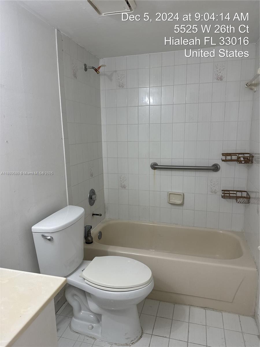 5530 West 26th Court, Unit 104 Hialeah, FL 33016 - Photo 5 of 14 a bathroom with a toilet a sink and bathtub