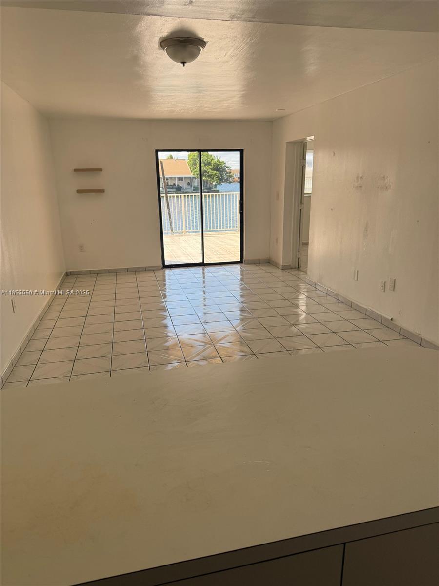 5530 West 26th Court, Unit 104 Hialeah, FL 33016 - Photo 8 of 14 an empty room with windows