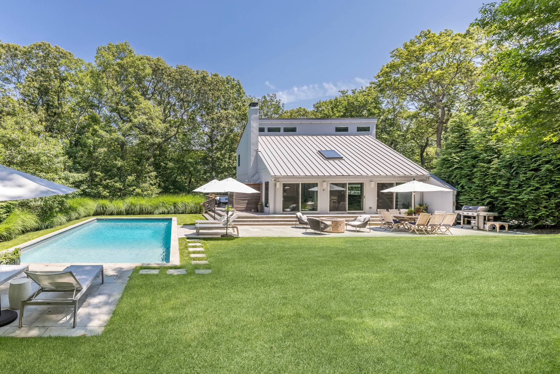 27 Landfall Road East Hampton, NY 11937 - Photo 1 of 24 a front view of a house with garden