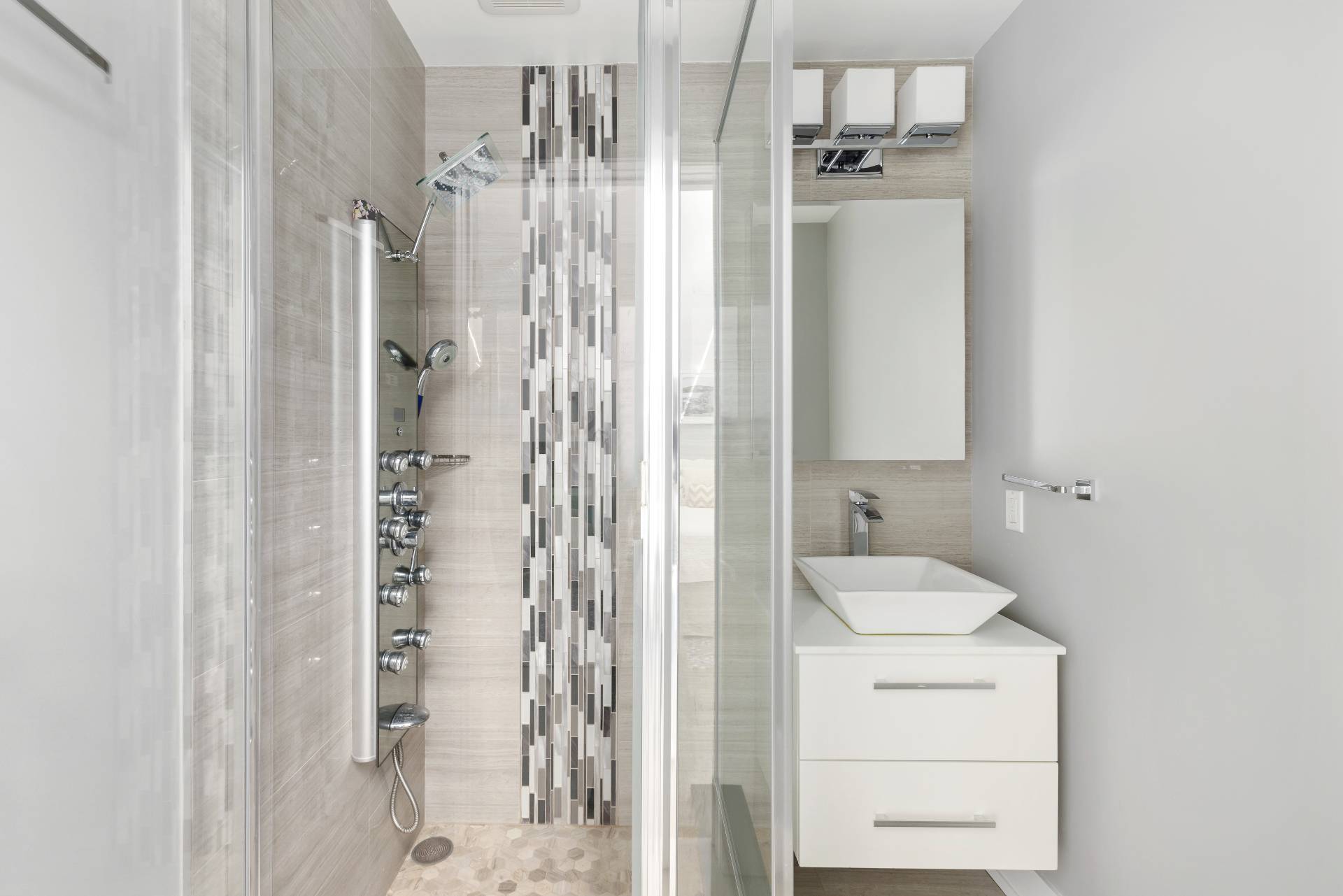 27 Landfall Road East Hampton, NY 11937 - Photo 14 of 24 a bathroom with a shower a sink and a mirror