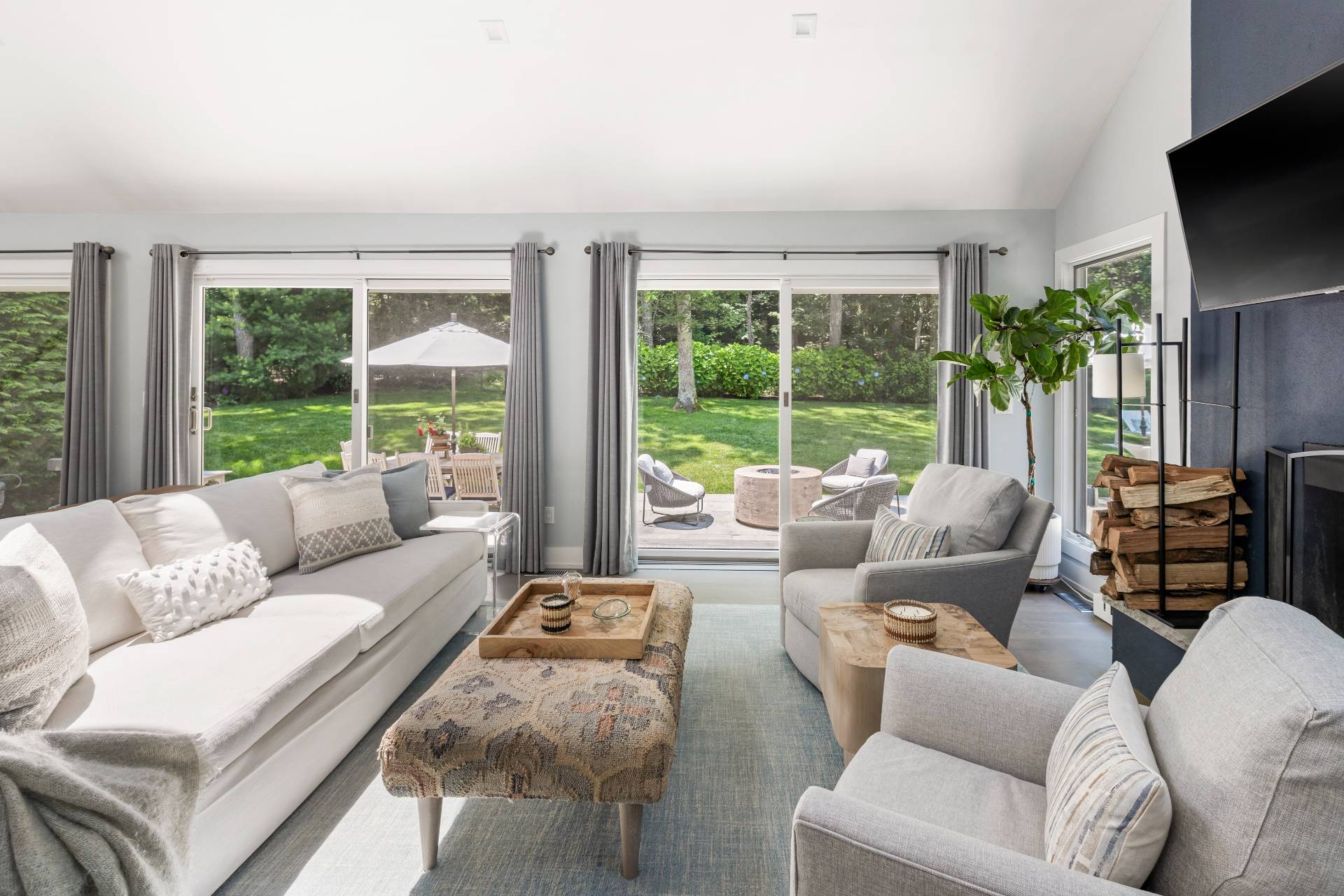 27 Landfall Road East Hampton, NY 11937 - Photo 5 of 24 a living room with furniture a large window and a flat screen tv
