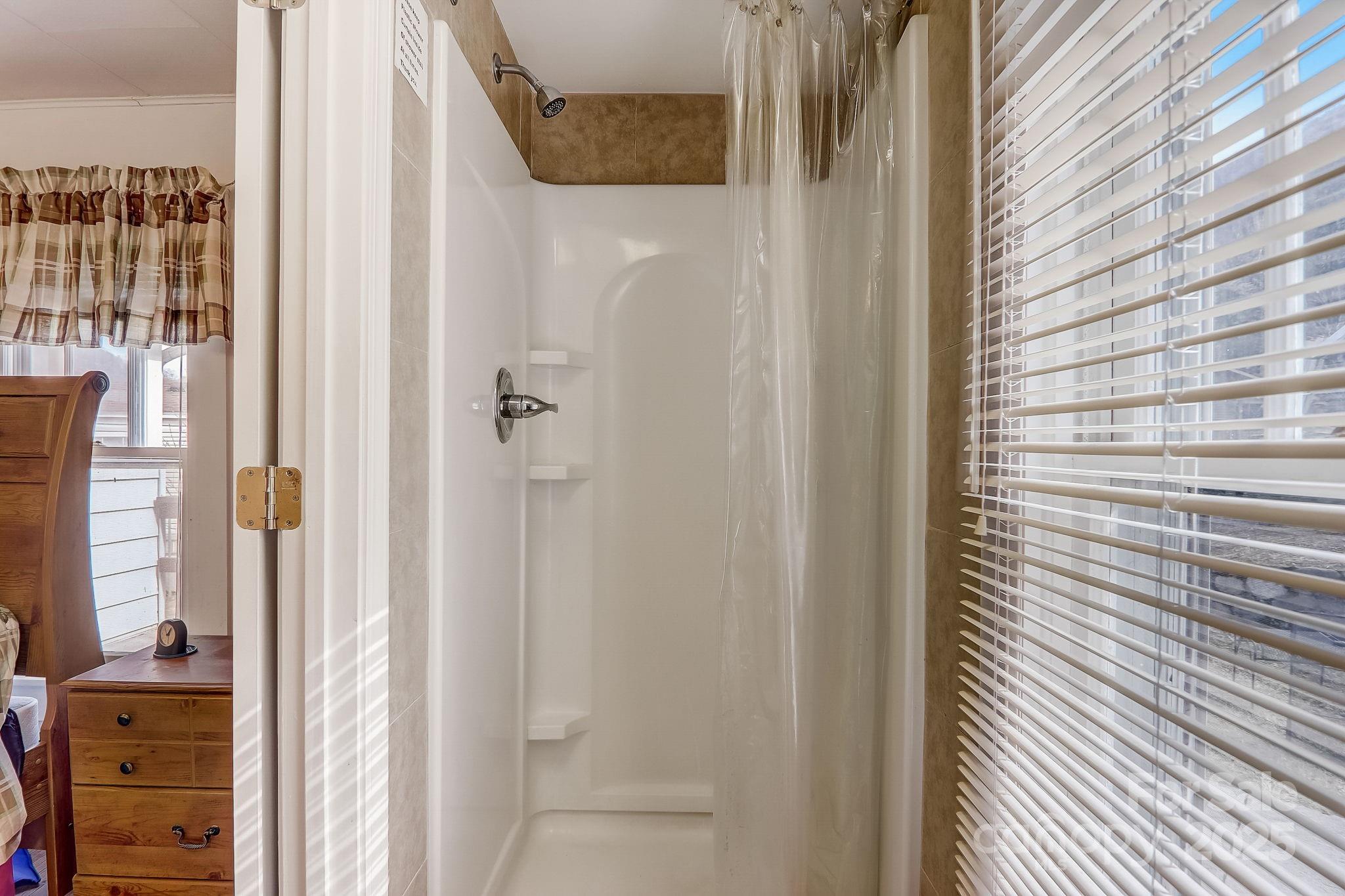 1639 Soco Road Maggie Valley, NC 28751 - Photo 14 of 15 a bathroom with a walk in closet and a bathroom