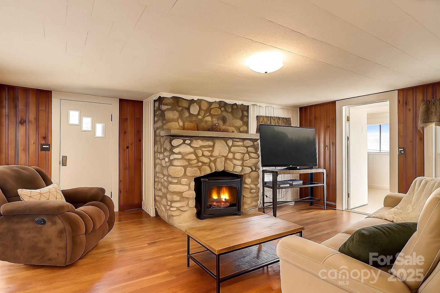 1639 Soco Road Maggie Valley, NC 28751 - Photo 3 of 15 a living room with furniture a flat screen tv and a fireplace
