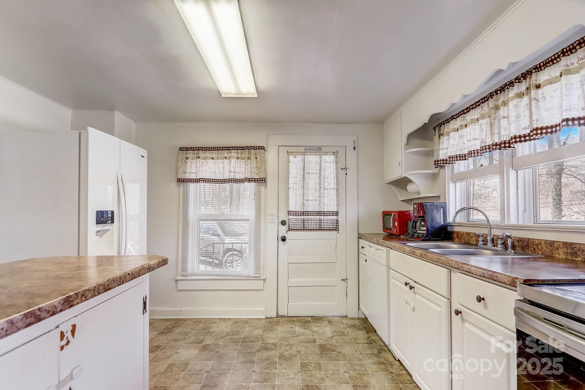 1639 Soco Road Maggie Valley, NC 28751 - Photo 6 of 15 a kitchen with granite countertop a sink cabinets stainless steel appliances and a window