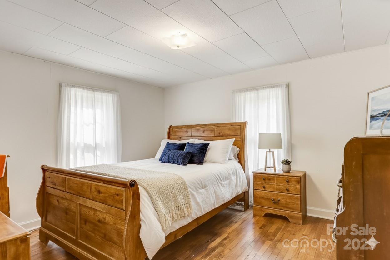 1639 Soco Road Maggie Valley, NC 28751 - Photo 10 of 15 a bedroom with a bed and wooden floor
