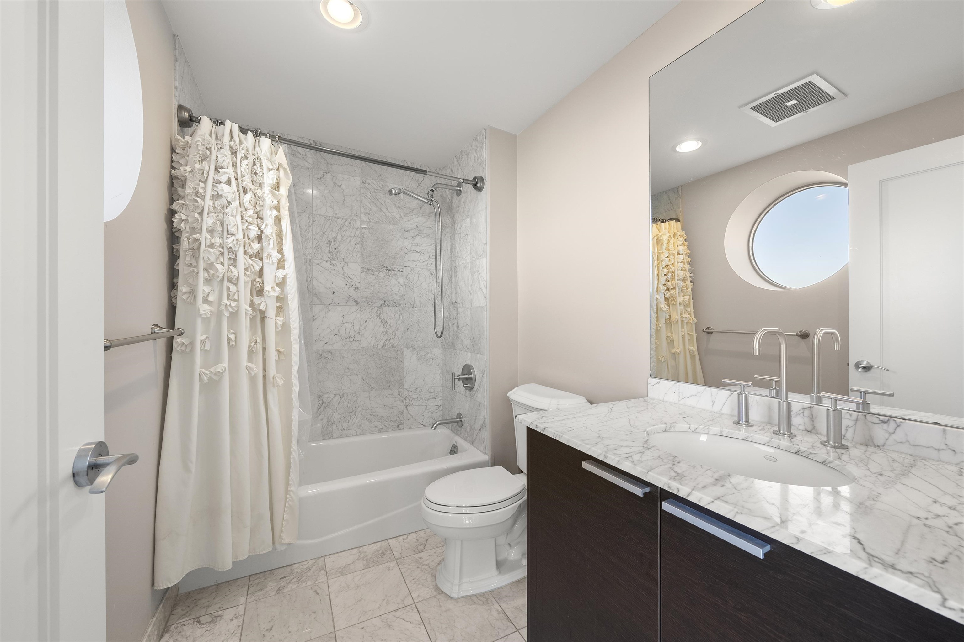 8100 River Road, Unit 1011 North Bergen, NJ 07047 - Photo 19 of 35 a bathroom with a granite countertop sink toilet a shower and a mirror