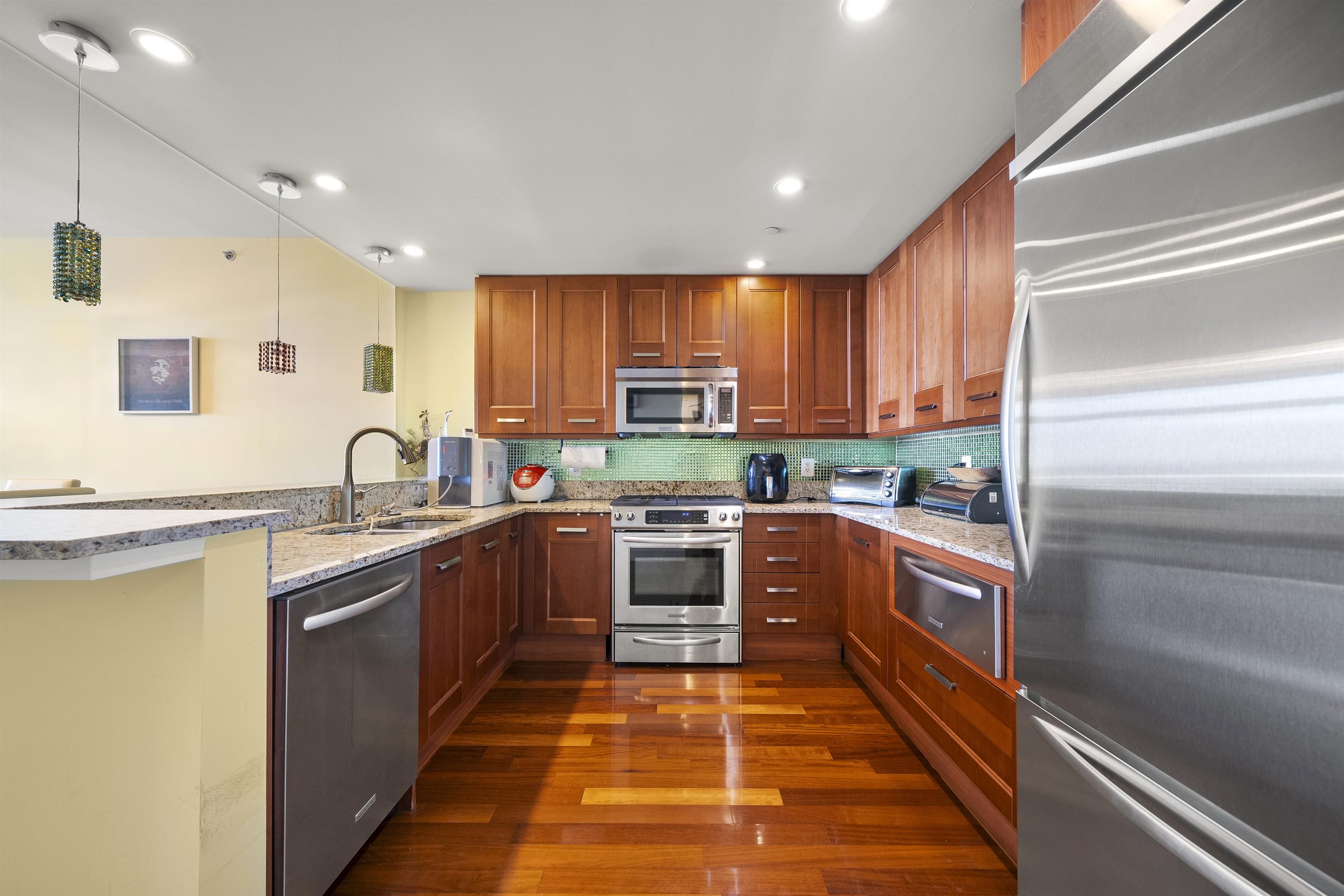 8100 River Road, Unit 1011 North Bergen, NJ 07047 - Photo 6 of 35 a large kitchen with stainless steel appliances granite countertop a stove top oven a sink and dishwasher