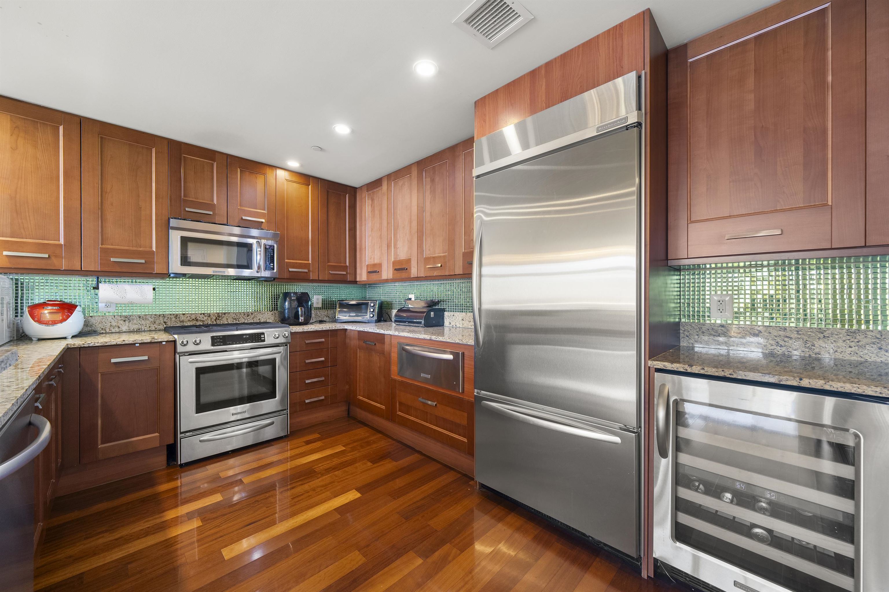 8100 River Road, Unit 1011 North Bergen, NJ 07047 - Photo 7 of 35 a kitchen with granite countertop stainless steel appliances and wooden cabinets