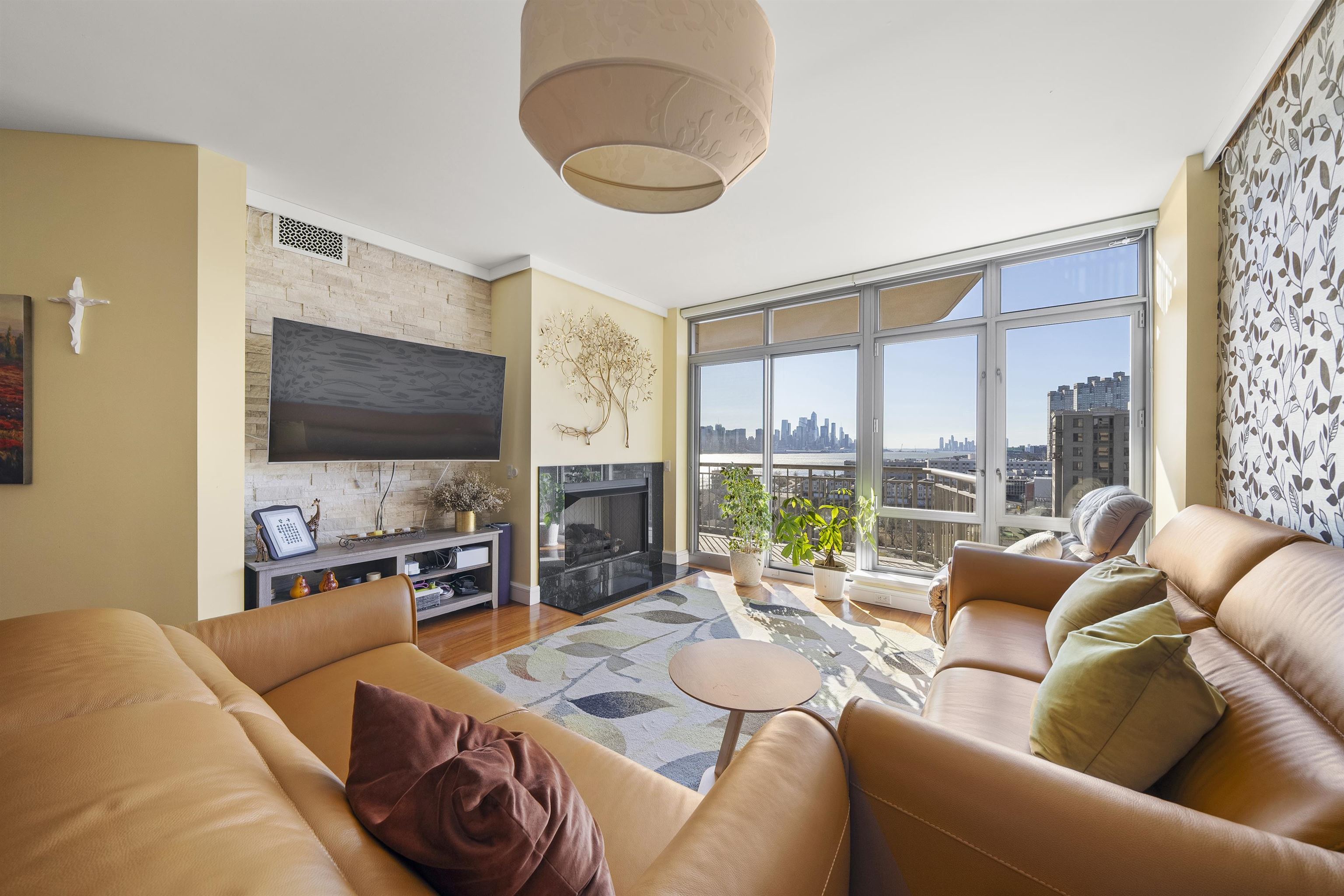 8100 River Road, Unit 1011 North Bergen, NJ 07047 - Photo 9 of 35 a living room with furniture a flat screen tv and a large window