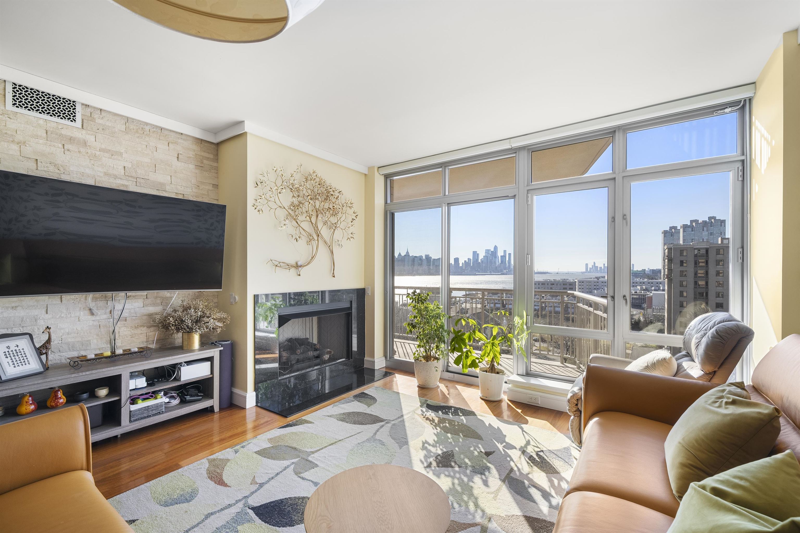 8100 River Road, Unit 1011 North Bergen, NJ 07047 - Photo 10 of 35 a living room with fireplace furniture and a flat screen tv