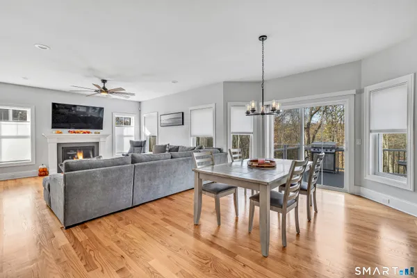 a living room with furniture a dining table and a flat screen tv