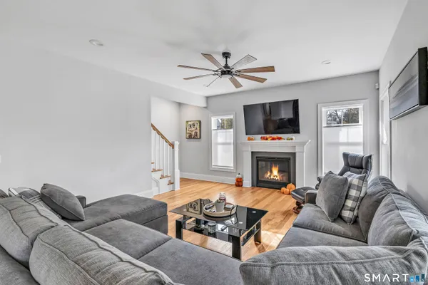 a living room with furniture a fireplace and a flat screen tv