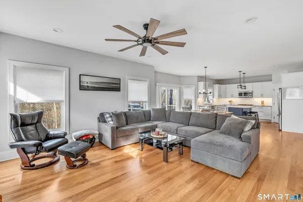 a living room with furniture and a wooden floor