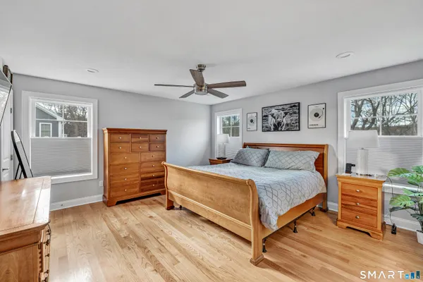 a bedroom with a bed and wooden floor