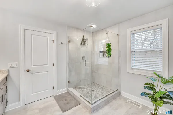 a bathroom with a shower and a sink
