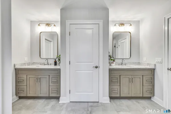 a bathroom with a granite countertop sink a mirror and a vanity