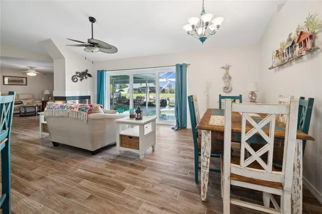 a living room with furniture dining table and a chandelier