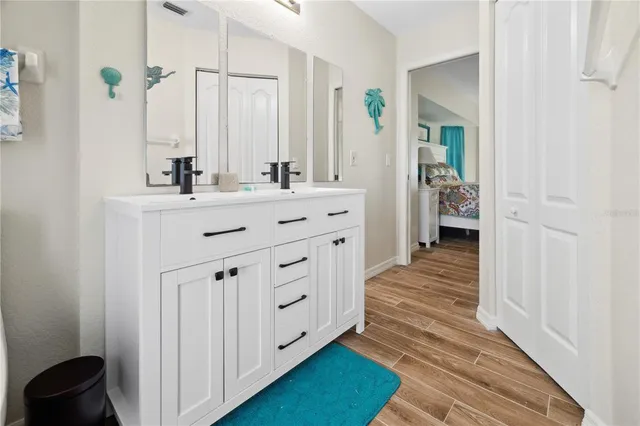 a spacious bathroom with a double vanity sink and a mirror