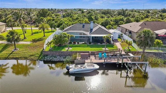 a aerial view of a house with swimming pool garden and patio