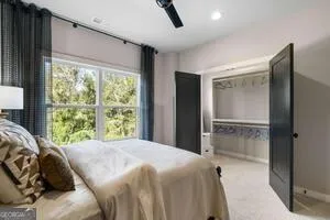 a bedroom with a bed and a large window