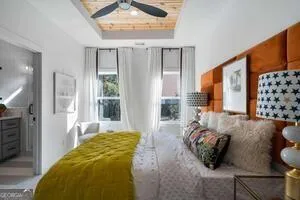 a bedroom with furniture and a large window