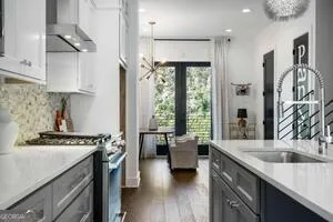 a kitchen with a stove a sink and a refrigerator