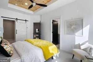 a bedroom with a bed and a chandelier