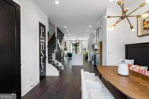 a hallway with dining table and wooden floor