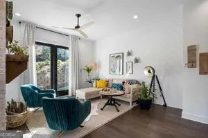 a living room with furniture and floor to ceiling windows