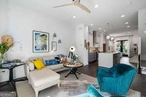 a living room with furniture and kitchen view