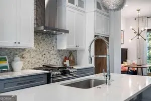 a kitchen with stainless steel appliances a sink a stove and a refrigerator