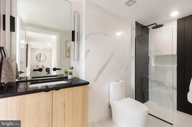 a spacious bedroom with a bed and a view of bathroom