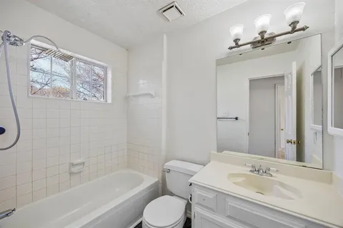 a bathroom with a sink a toilet and bathtub