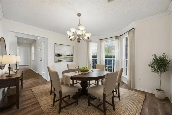 a view of a dining room with furniture and wooden floor