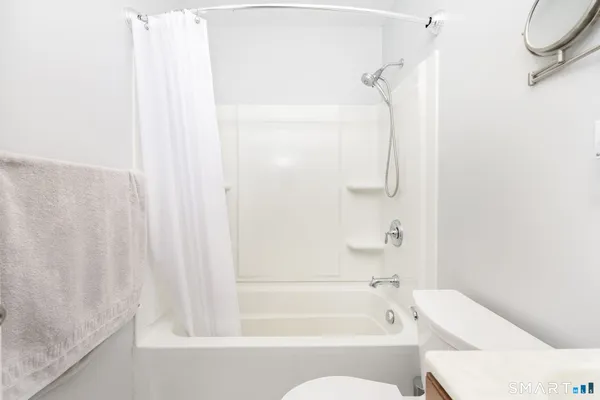 a bathroom with a bathtub and shower