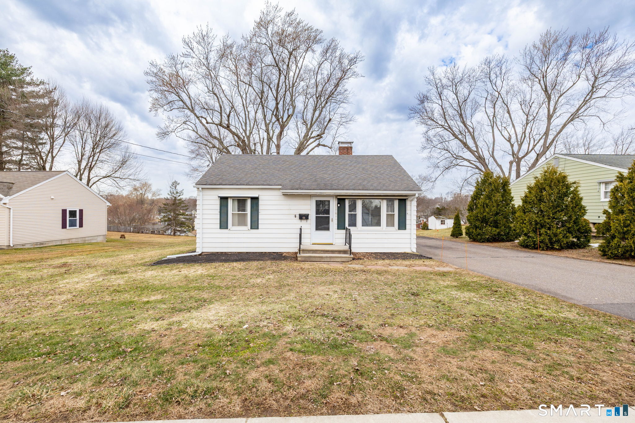 80 West Street Windsor Locks, CT 06096 - Photo 2 of 38 a front view of house with yard and trees around