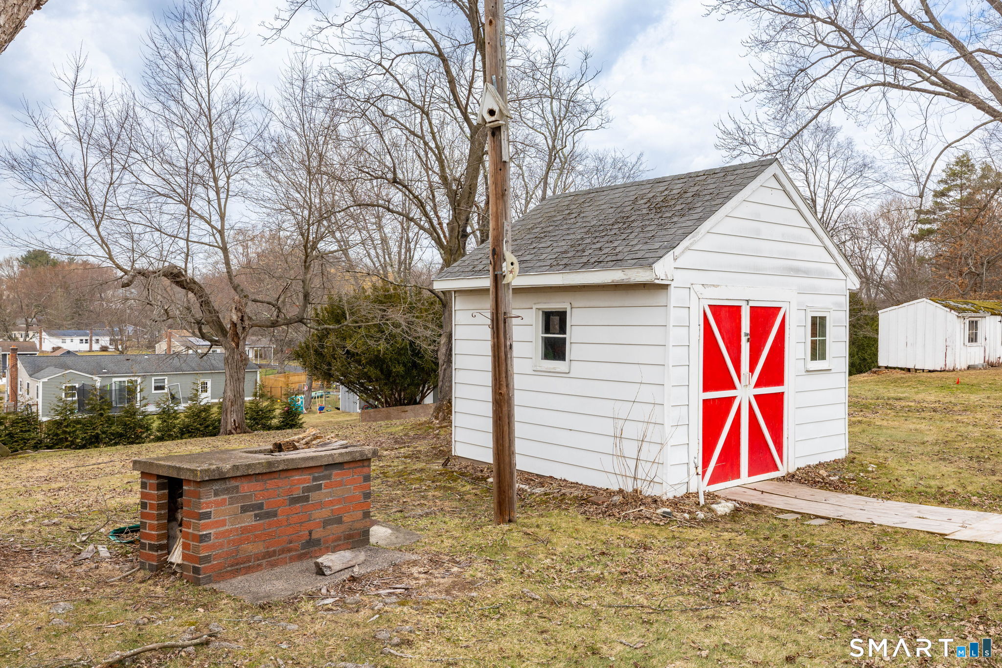 80 West Street Windsor Locks, CT 06096 - Photo 26 of 38 a backyard of a house with barbeque oven and outdoor seating