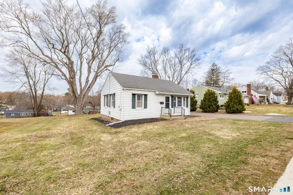 a view of a house with a yard covered with snow in the yard