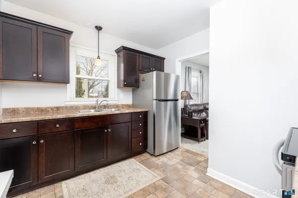 a kitchen with a refrigerator and a sink