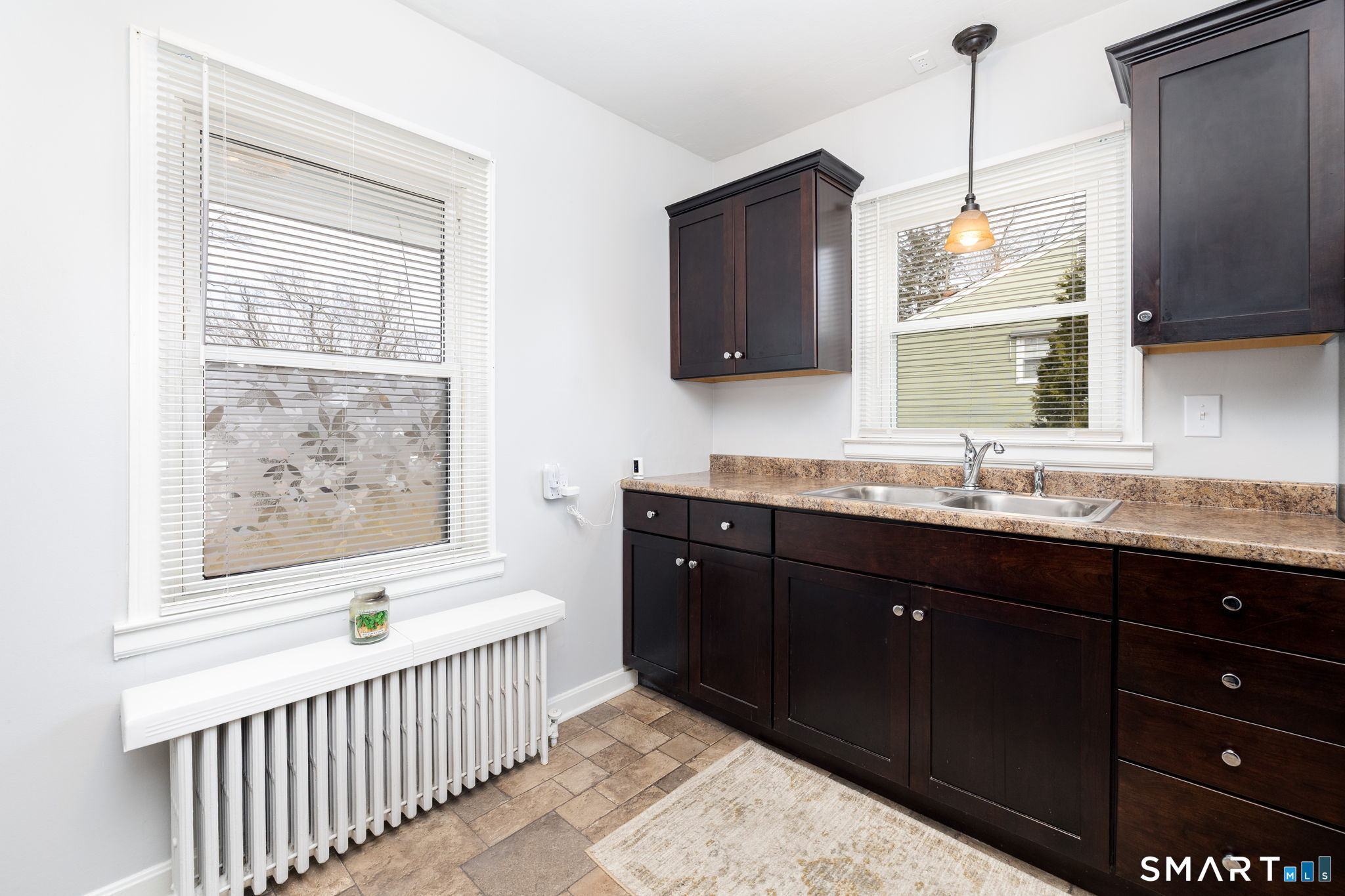 80 West Street Windsor Locks, CT 06096 - Photo 7 of 38 a bathroom with a granite countertop sink a large mirror and a window