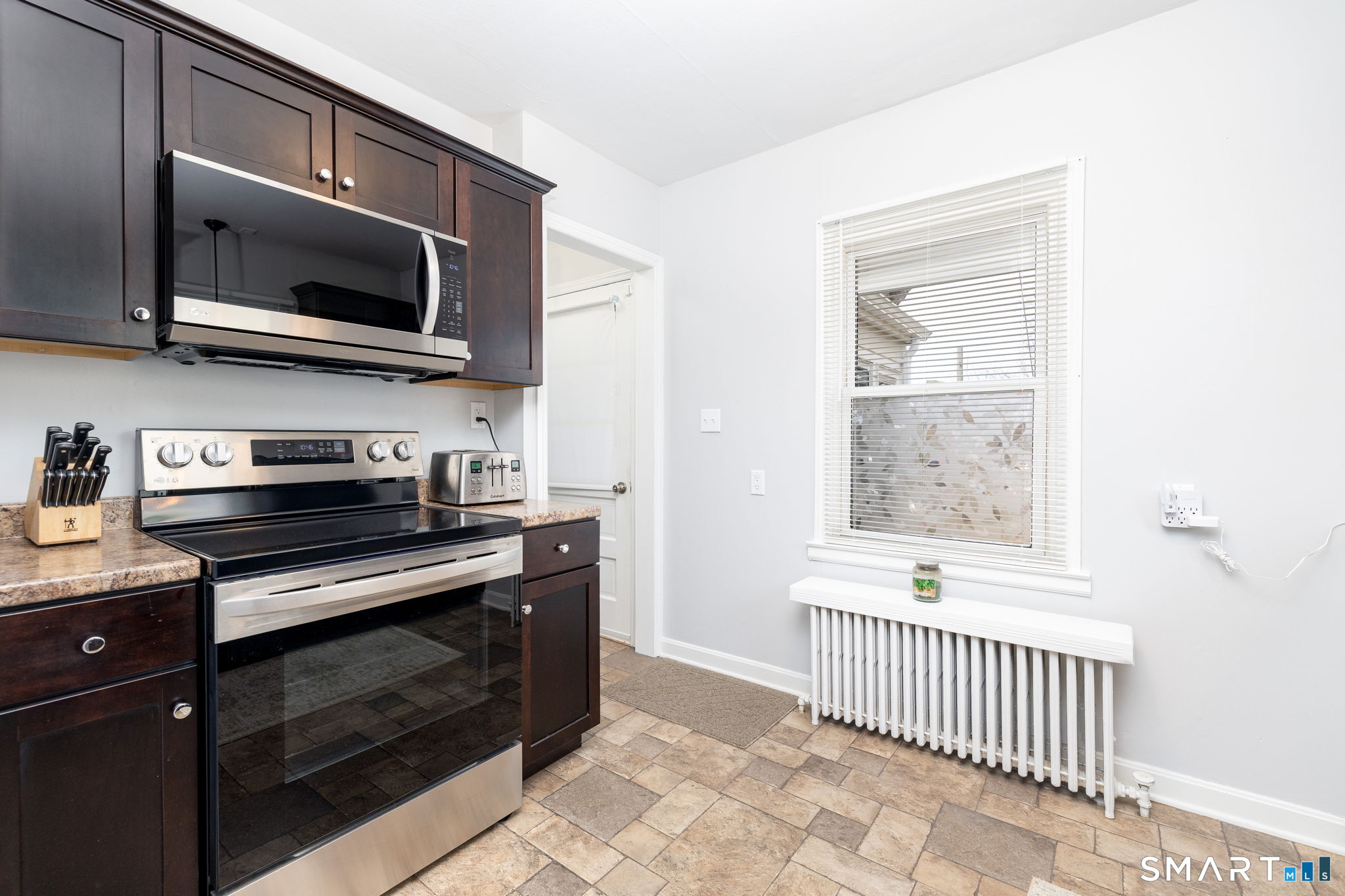 80 West Street Windsor Locks, CT 06096 - Photo 8 of 38 a kitchen with stainless steel appliances a stove a microwave and cabinets