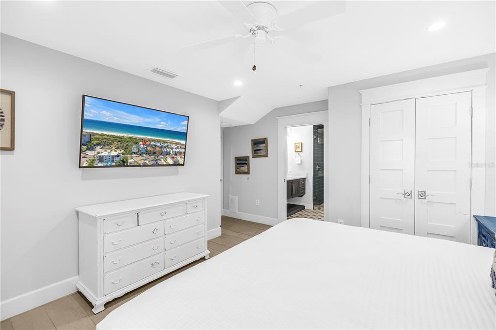 316 Beach Road Sarasota, FL 34242 - Photo 11 of 98 a bedroom with a bed and a chandelier