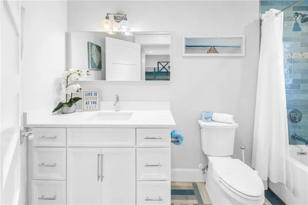 a bathroom with a sink toilet a mirror and shower