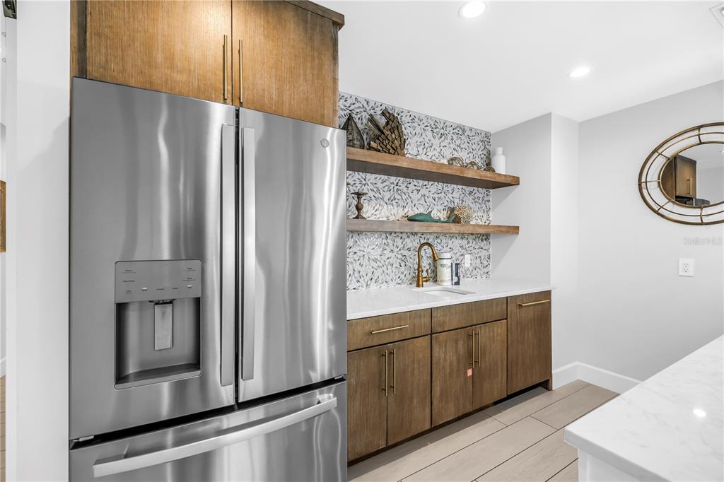 316 Beach Road Sarasota, FL 34242 - Photo 55 of 98 a kitchen with stainless steel appliances a refrigerator and cabinets