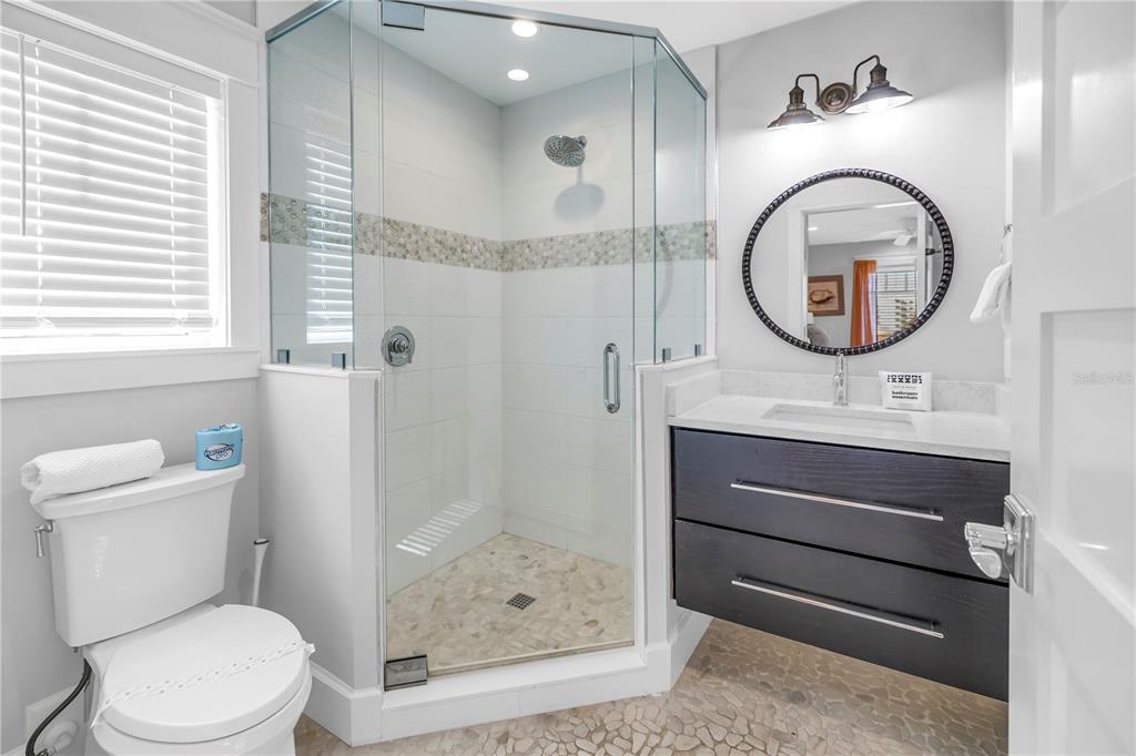 316 Beach Road Sarasota, FL 34242 - Photo 60 of 98 a bathroom with a toilet a sink and a mirror