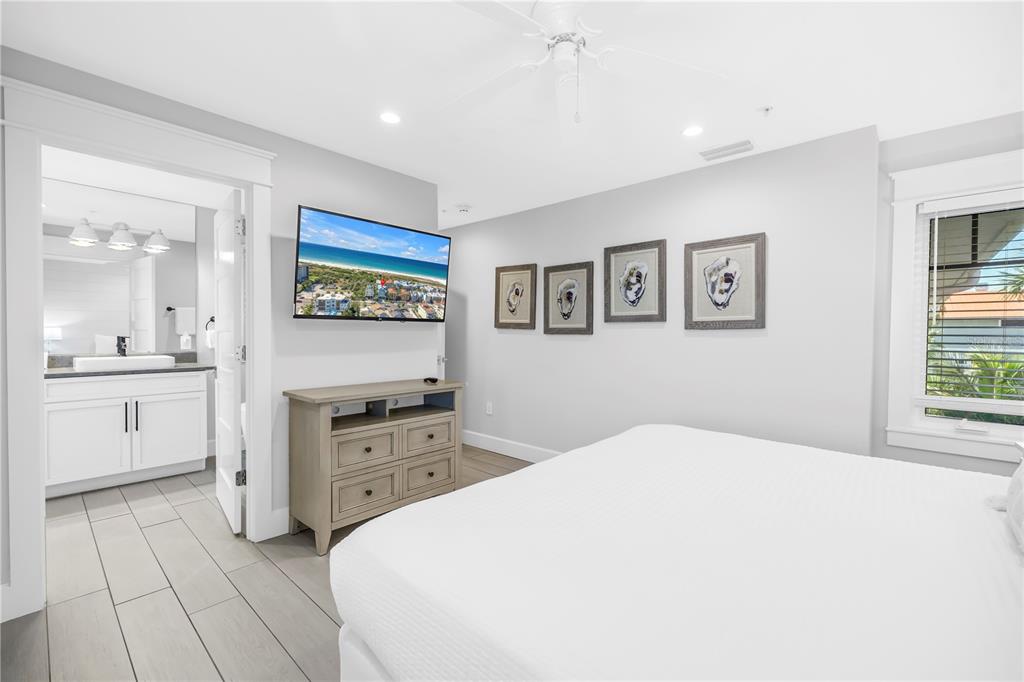 316 Beach Road Sarasota, FL 34242 - Photo 62 of 98 a spacious bedroom with a bed and a chandelier