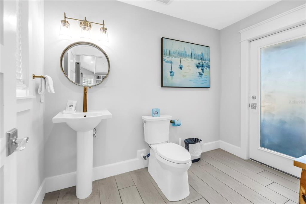 316 Beach Road Sarasota, FL 34242 - Photo 67 of 98 a bathroom with a toilet a sink and a mirror