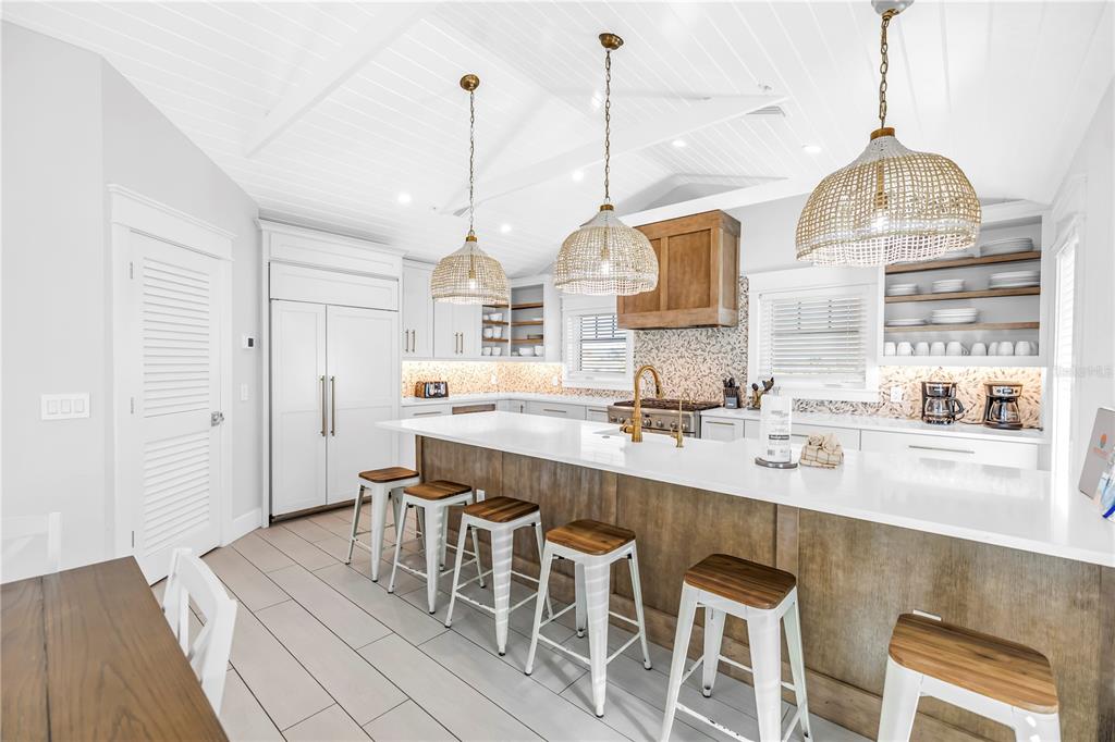 316 Beach Road Sarasota, FL 34242 - Photo 76 of 98 a kitchen with stainless steel appliances granite countertop a sink a stove and a wooden floors
